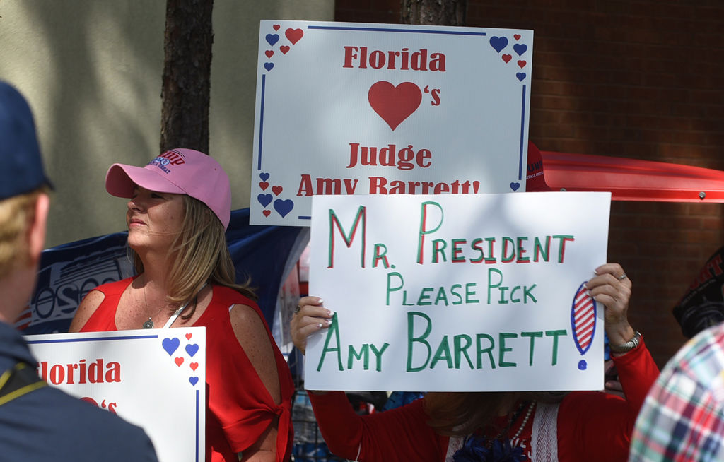 People holding placards in support of Judge Amy Coney Barrett as a potential nominee for Supreme Court Justice as supporters of U.S President Donald Trump arrive at a Great American Comeback campaign rally at the Jacksonville JetPort at Cecil Airport.