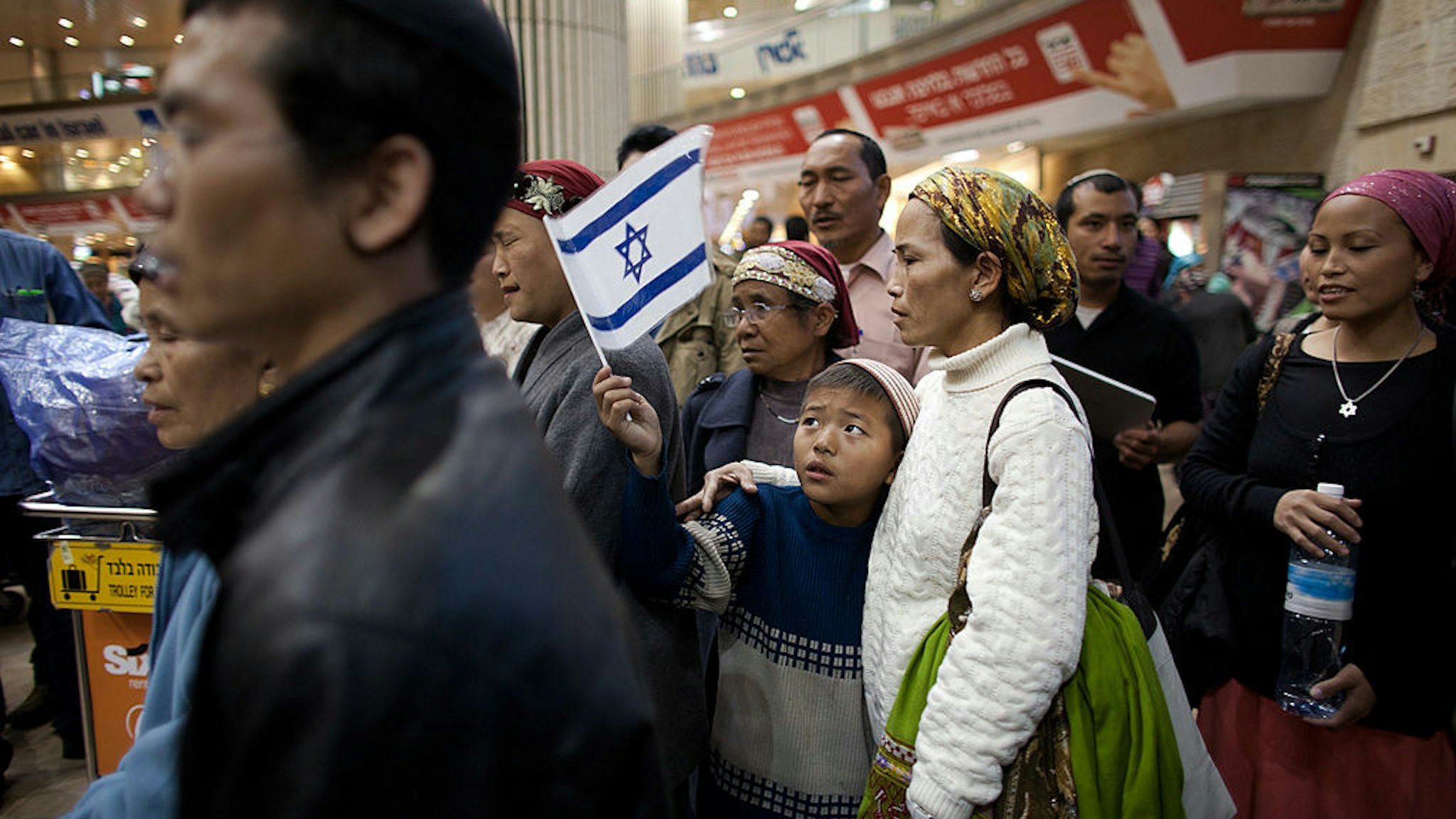 Jewish immigrants of the Bnei Menashe tribe reunite with relatives at the Ben Gurion airport on December 24, 2012 near Tel Aviv, Israel.