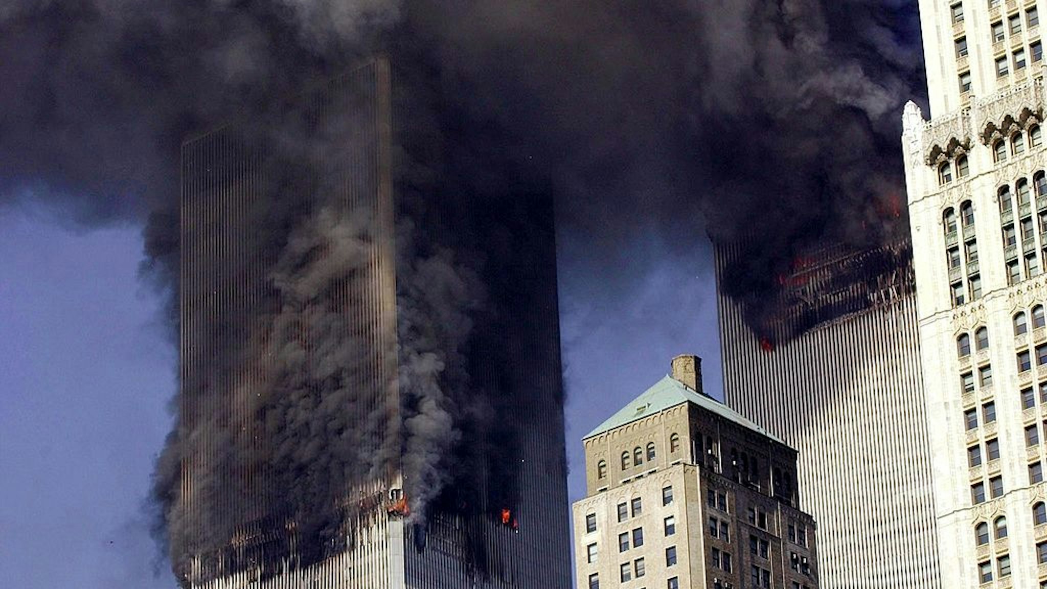 The twin towers of World Trade Center burn after two planes crashed into each building 11 September, 2001, in New York.
