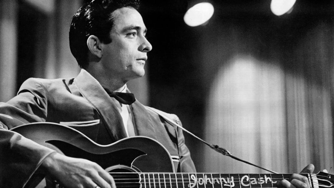 Country singer/songwriter Johnny Cash performs onstage with an acoustic guitar in Sun Records publicity shot in 1957. (Photo by Michael Ochs Archives/Getty Images)