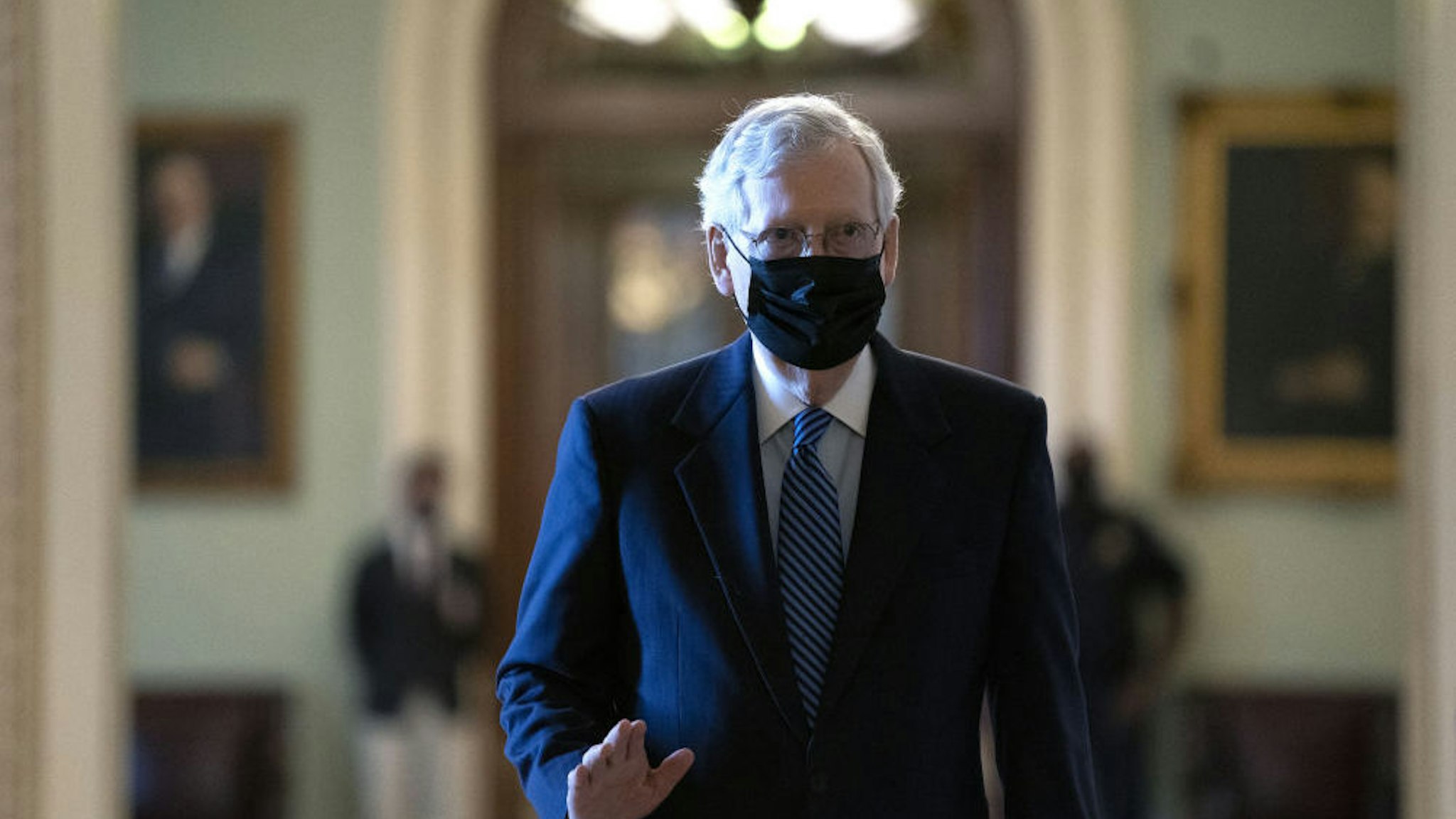 Senate Majority Leader Mitch McConnell, a Republican from Kentucky, center, wears a protective mask as he walks to his office at the U.S. Capitol in Washington, D.C., U.S., on Tuesday, Sept. 15, 2020. A 50-member group of House Democrats and Republicans will release a $1.52 trillion coronavirus stimulus plan today in a long-shot attempt to break a months-long deadlock on providing relief to the pandemic-battered U.S. economy.