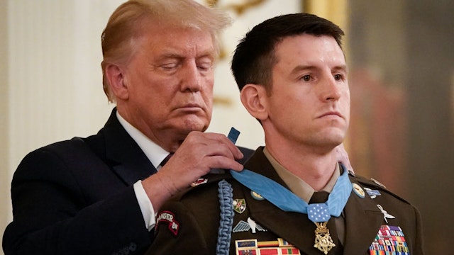 WASHINGTON, DC - SEPTEMBER 11: U.S. President Donald Trump presents the Medal of Honor to Sergeant Major Thomas P. Payne, United States Army, for conspicuous gallantry in the East Room of the White House on September 11, 2020 in Washington, DC. On October 22, 2015, during a daring nighttime hostage rescue in Kirkuk Province, Iraq, then-Sergeant First Class Payne led a combined assault team charged with clearing one of two buildings known to house hostages. His actions were key to liberating 75 hostages during a rescue mission that resulted in 20 enemy fighters killed in action.