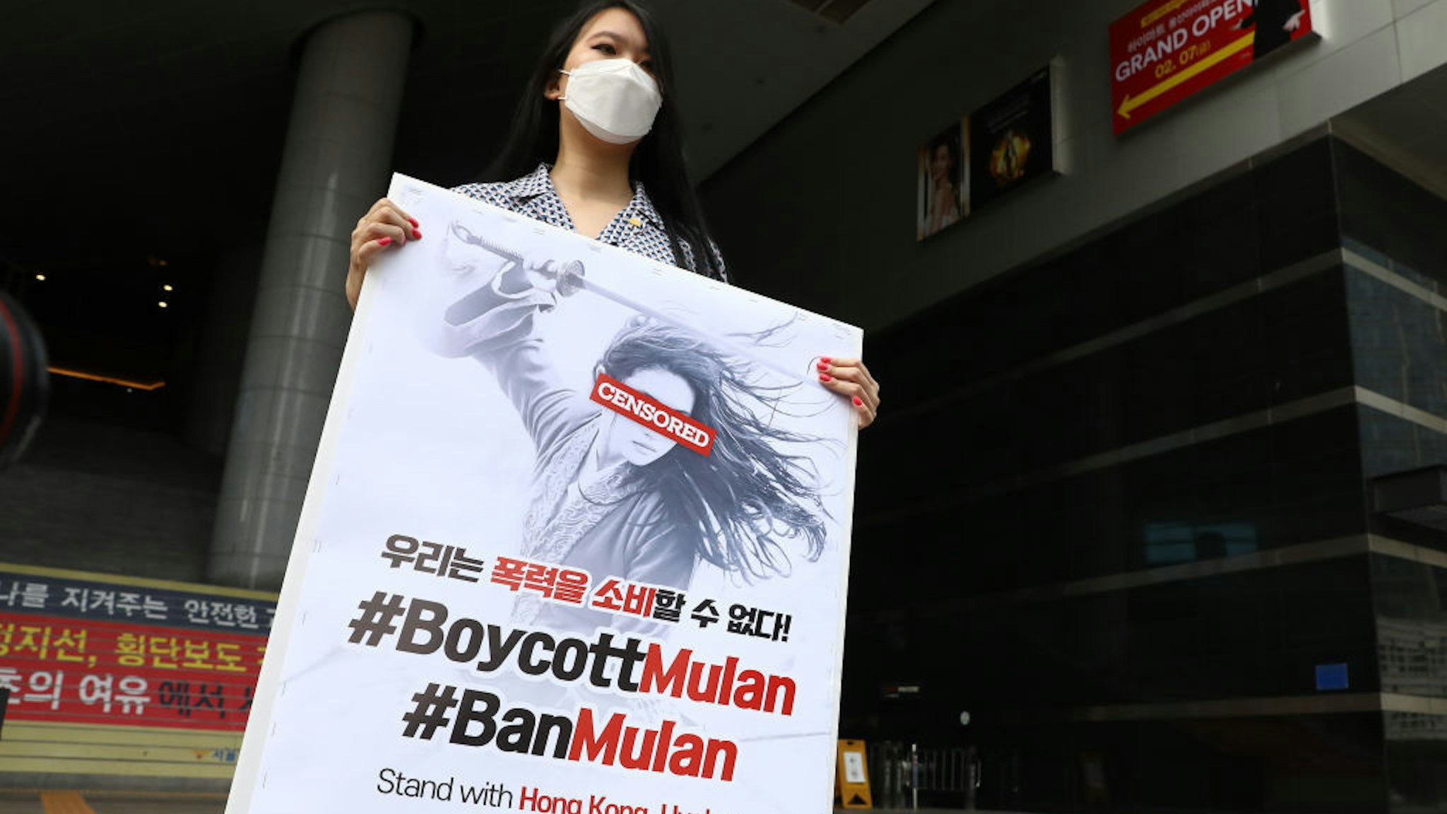 A South Korean supporter of Hong Kong protesters holds a placard in a lone rally calling for a boycott of the Disney's live-action remake of "Mulan" ourside a theatre on September 17, 2020 in Seoul, South Korea. With the South Korean released of "Mulan" just a day away, refreshed calls to boycott the film have been growing here on social media due to a few controversies. The film has been under fire since its lead actress Liu Yifei posted comments supporting Hong Kong's police in their crackdown on pro-democracy demonstrations last year. The movie was released in South Korea on September 17. (Photo by Chung Sung-Jun/Getty Images)