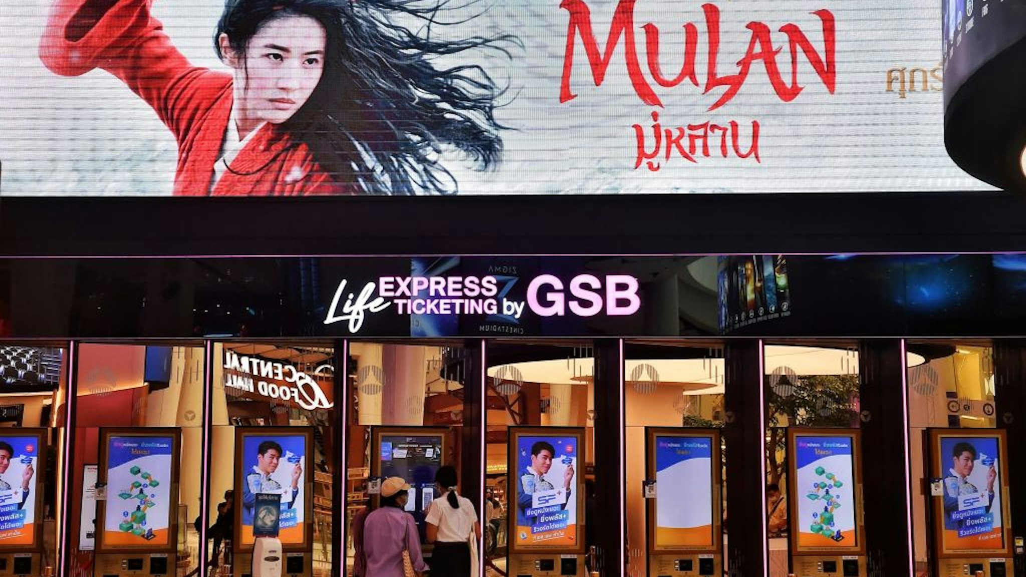 People buy tickets for Disneys Mulan film at a cinema inside a shopping mall in Bangkok on September 8, 2020. - Disney's "Mulan" remake is facing fresh boycott calls after it emerged some of the blockbuster was filmed in China's Xinjiang, where widespread rights abuses against the region's Muslim population have been widely documented.