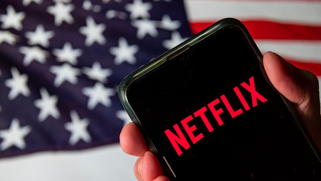 CHINA - 2020/08/13: In this photo illustration the American global on-demand Internet streaming media provider Netflix logo is seen on an Android mobile device with United States of America flag in the background.