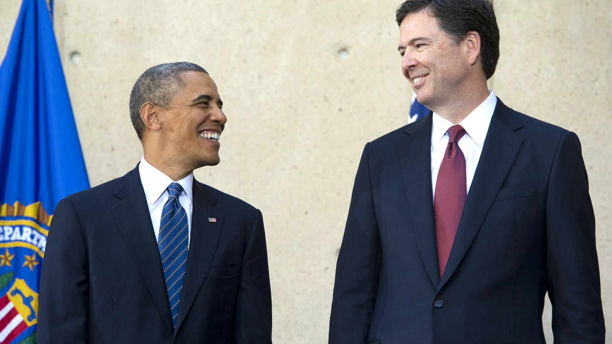 US President Barack Obama speaks with new FBI Director James Comey (R) during an installation ceremony at Federal Bureau of Investigation Headquarters in Washington, DC, October 28, 2013. Comey replaces longtime FBI Director Robert Mueller, who recently retired after 12 years leading the organization.