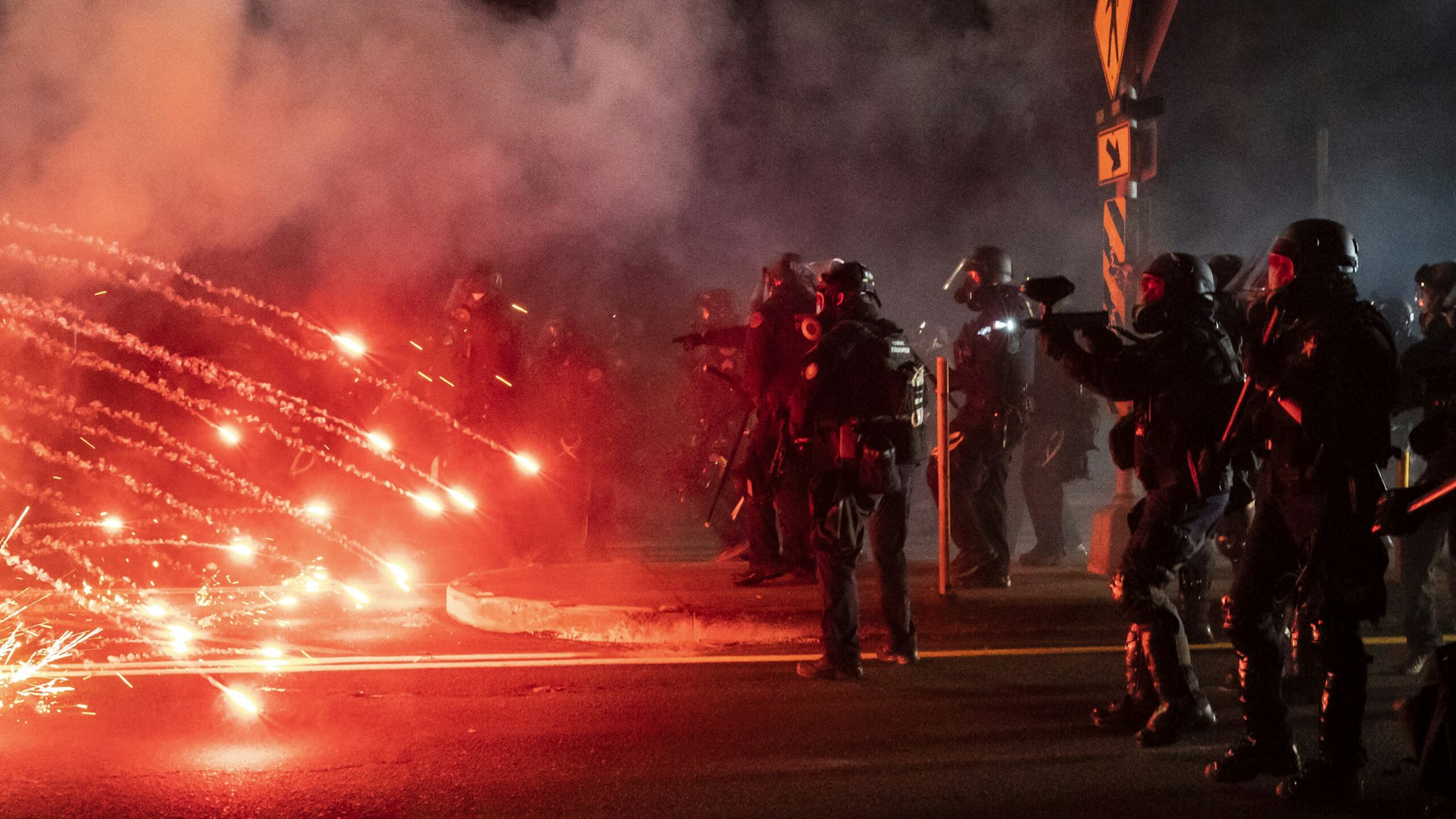 PORTLAND, OREGON - SEPTEMBER 5: Oregon State Troopers and Portland police advance through tear gas and fire works while dispersing a protest against police brutality and racial injustice on September 5, 2020 in Portland, Oregon. Portland has seen nightly protests for the past 100 days following the death of George Floyd in police custody.