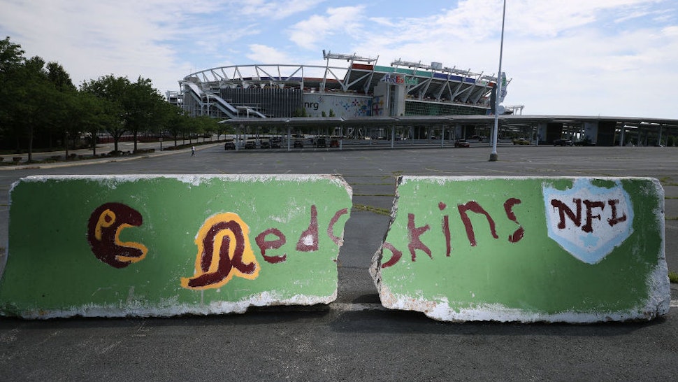 LANDOVER, MARYLAND - JULY 13: A hand-painted concrete barrier stands in the parking lot of FedEx Field, home of the NFL's Washington Redskins team July 13, 2020 in Landover, Maryland. The team announced Monday that owner Daniel Snyder and coach Ron Rivera are working on finding a replacement for its racist name and logo after 87 years.