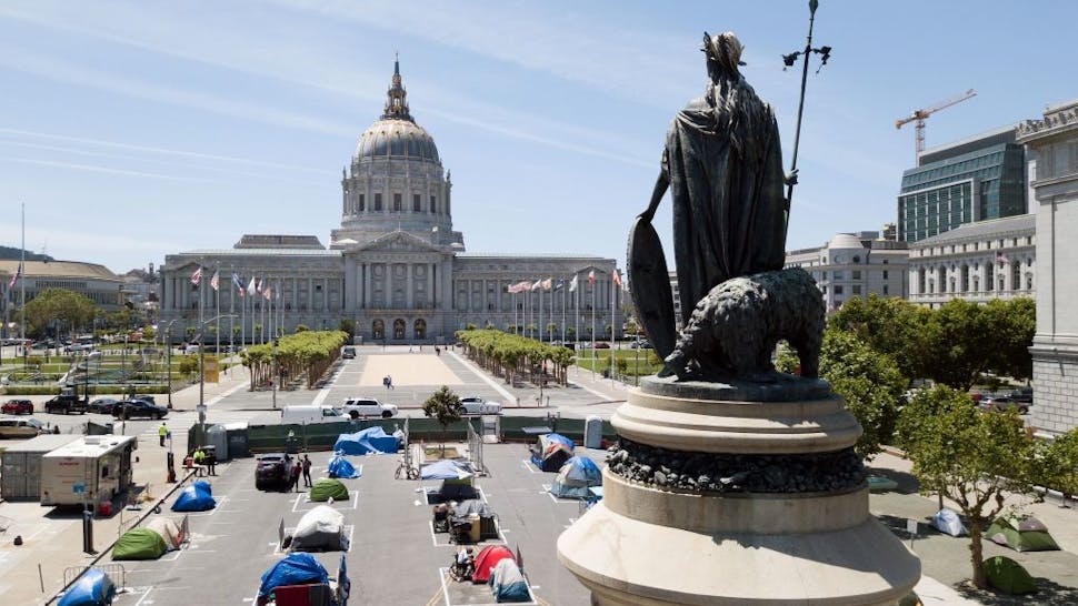 An aerial view shows a statue of Eureka, part of the Pioneer Monument, looking over squares painted on the ground to encourage homeless people to keep to social distancing at a city-sanctioned homeless encampment across from City Hall in San Francisco, California, on May 22, 2020, amid the novel coronavirus pandemic.