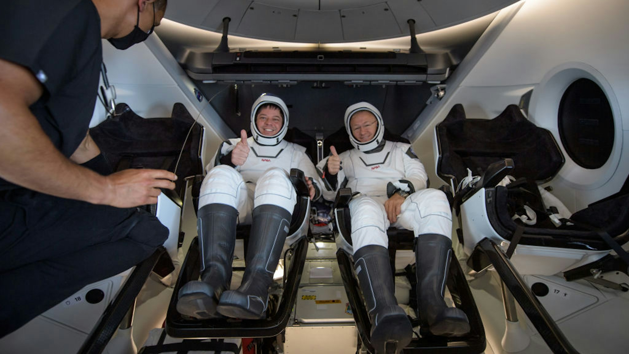 In this handout image provided by NASA, NASA astronauts Robert Behnken (L) and Douglas Hurley are seen inside the SpaceX Crew Dragon capsule spacecraft which landed in the Gulf of Mexico after completing the Demo-2 mission to the International Space Station on August 2, 2020 off the coast of Pensacola, Florida. The Demo-2 mission is the first launch with astronauts of the SpaceX Crew Dragon spacecraft and Falcon 9 rocket to the International Space Station as part of the agency's Commercial Crew Program. The test flight serves as an end-to-end demonstration of SpaceXs crew transportation system. Behnken and Hurley launched at 3:22 p.m. EDT on Saturday, May 30, from Launch Complex 39A at the Kennedy Space Center. A new era of human spaceflight is set to begin as American astronauts once again launch on an American rocket from American soil to low-Earth orbit for the first time since the conclusion of the Space Shuttle Program in 2011. (Photo by Bill Ingalls/NASA via Getty Images)