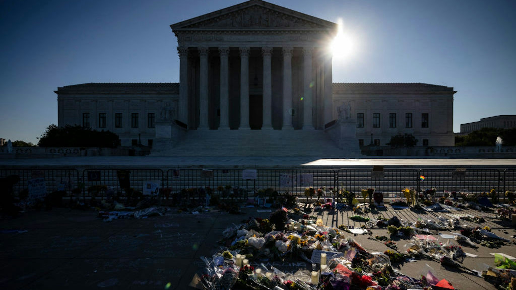 WASHINGTON, DC - SEPTEMBER 20: People place flowers at a makeshift memorial to honor Supreme Court Justice Ruth Bader Ginsburg in front of the US Supreme Court on September 20, 2020 in Washington, DC. Justice Ginsburg has died at age 87 after a battle with pancreatic cancer. (Photo by Samuel Corum/Getty Images)