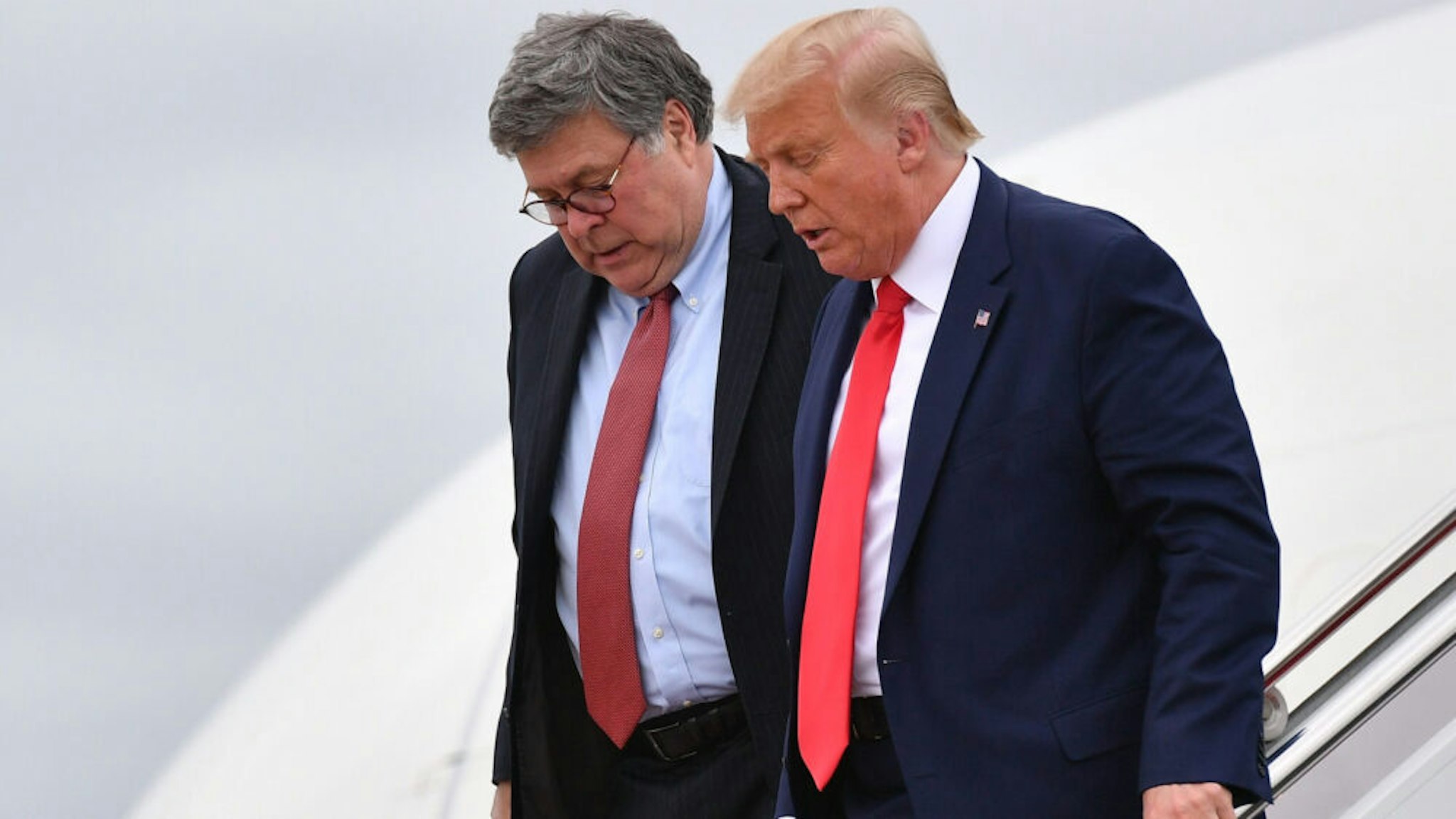 US President Donald Trump (R) and US Attorney General William Barr step off Air Force One upon arrival at Andrews Air Force Base in Maryland on September 1, 2020. - US President Donald Trump said September 1, 2020 on a visit to protest-hit Kenosha, Wisconsin that recent anti-police demonstrations in the city were acts of "domestic terror" committed by violent mobs.