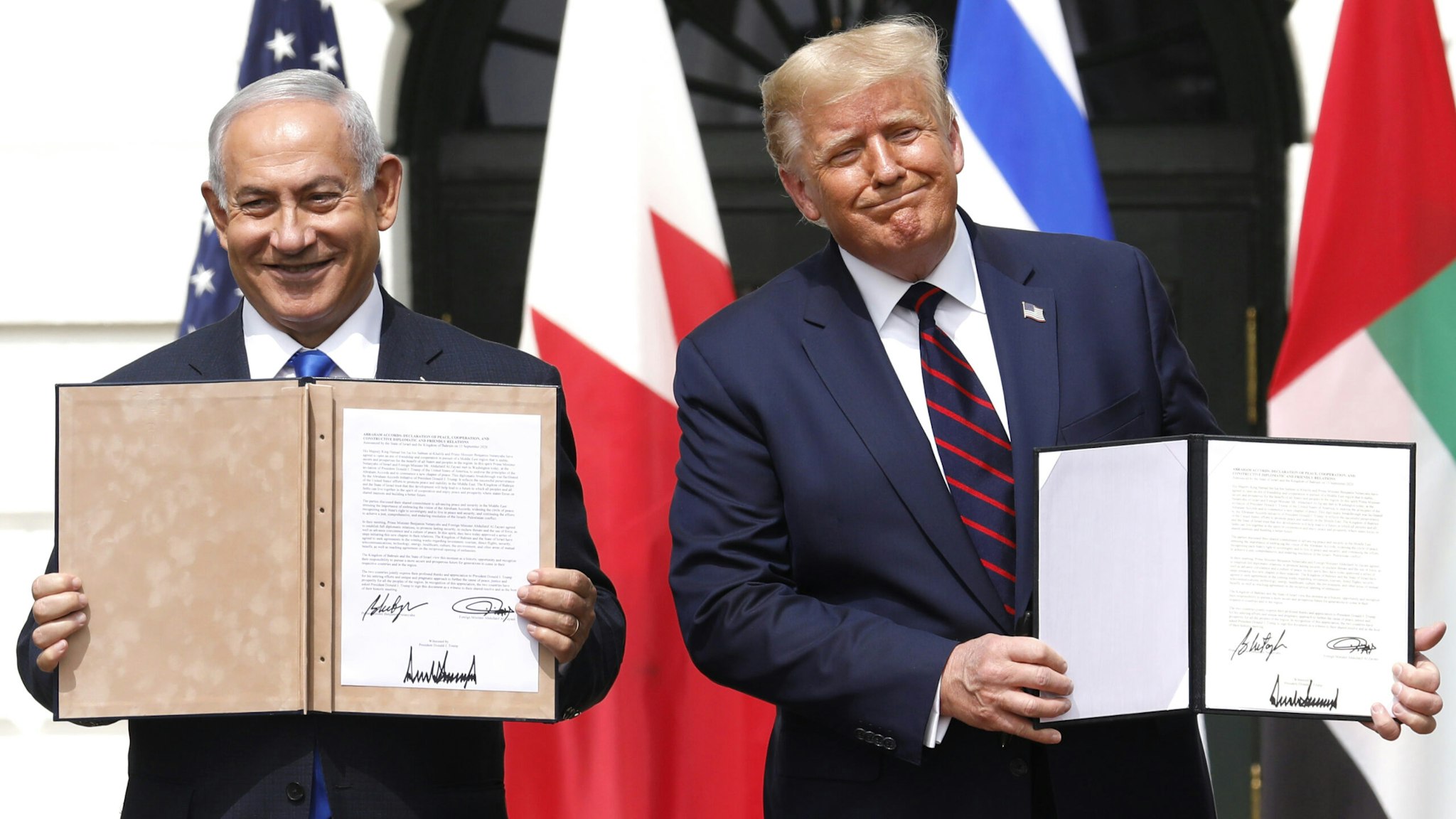 U.S. President Donald Trump and Benjamin Netanyahu, Israel's prime minister, left, hold signed documents during an Abraham Accords signing ceremony event on the South Lawn of the White House in Washington, D.C., U.S., on Tuesday, Sept. 15, 2020. The United Arab Emirates and Bahrain signed landmark agreements on Tuesday to move toward establishing normal relations with Israel, setting in motion a potentially historic shift in Mideast politics at a White House ceremony hosted by President Donald Trump.