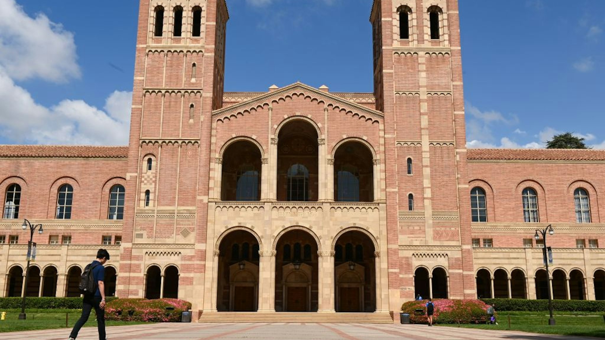 A student walks toward Royce Hall on the campus of University of California at Los Angeles (UCLA) in Los Angeles, California on March 11, 2020. - Starting this week many southern California universities including UCLA will suspend in-person classes due to coronavirus concerns. (Photo by Robyn Beck / AFP) (Photo by ROBYN BECK/AFP via Getty Images)