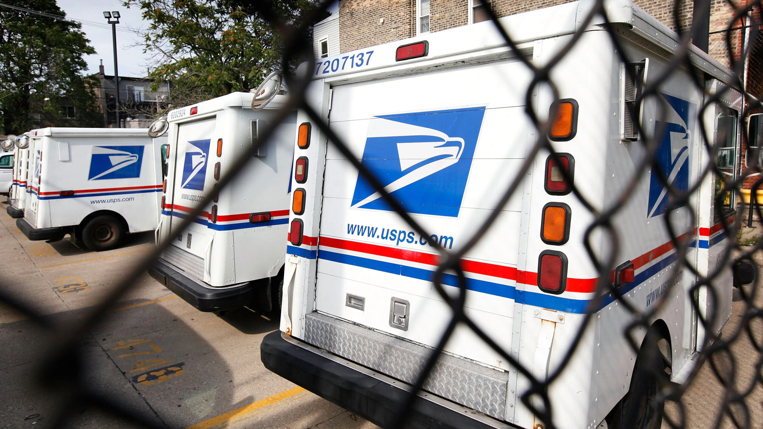 CHICAGO - AUGUST 25: United States Postal Service trucks sit outside the Roberto Clemente Post Office August 25, 2009 in Chicago, Illinois. The Postal Service announced it would offer $15,000 for buyouts of up to 30,000 employees eligible for retirement, early retirement, or those in select positions.