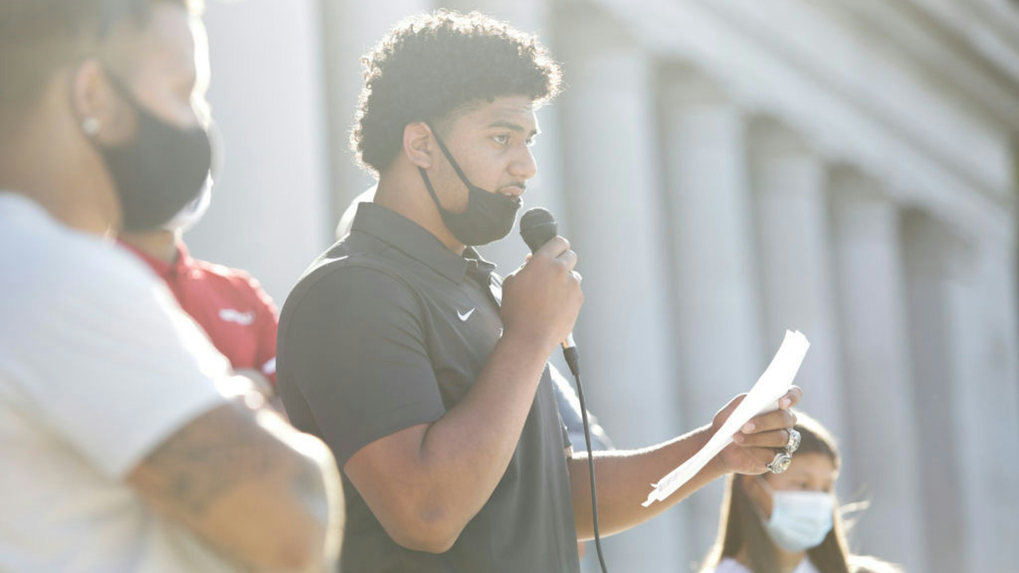 Eastside Catholic High School football player J.T. Tuimoloau, one of the top recruits in the US, speaks during a rally at the state capitol organized by Student Athletes of Washington (SAW), a group that formed to protest the postponement of fall sports due to COVID-19, in Olympia, Washington on September 3, 2020. (Photo by Jason Redmond / AFP) (Photo by JASON REDMOND/AFP via Getty Images)