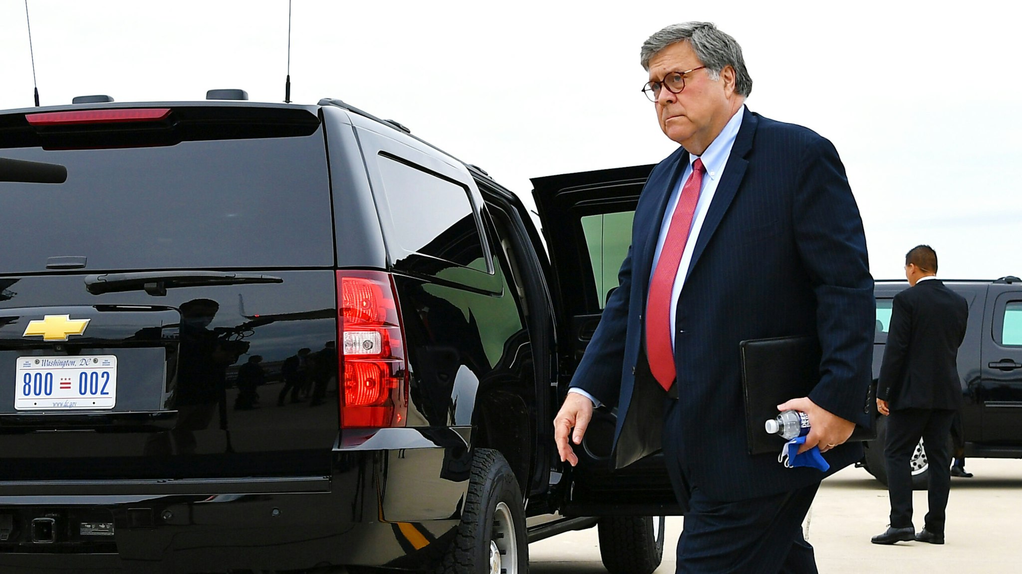 US President Donald Trump (C), with US Attorney General William Barr, arrive at Waukegan National Airport in Waukegan, Illinois en route Kenosha, Wisconsin, on September 1, 2020. - Trump is heading to Kenosha, Wisconsin to meet with law enforcement officials and to survey damage following civil unrest in the city.