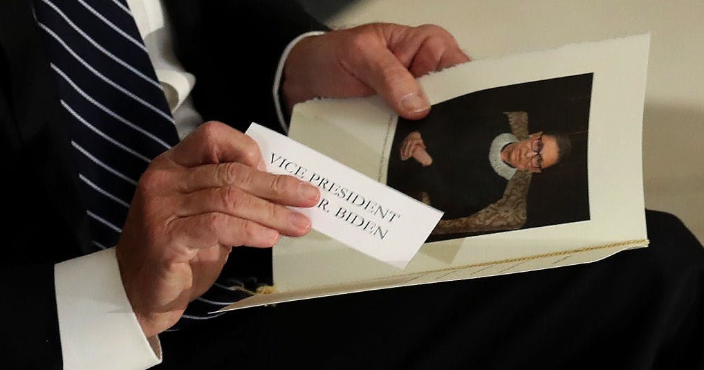 Former Vice President and Democratic presidential nominee Joe Biden puts his name tag into his program during a memorial for the late Associate Justice Ruth Bader Ginsburg in the Statuary Hall, where she lies in state at the US Capitol, September 25, 2020 in Washington, DC. (Photo by Chip Somodevilla / POOL / AFP) (Photo by