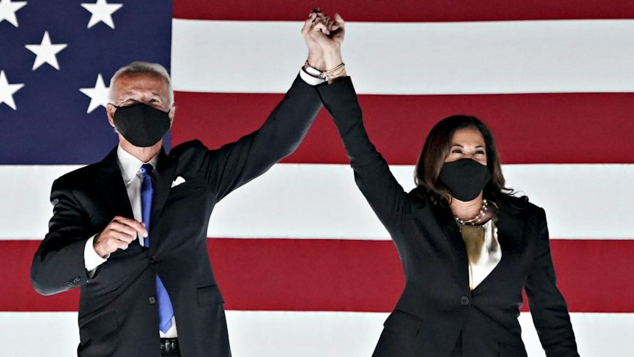 Former Vice President Joe Biden, Democratic presidential nominee, left, and Senator Kamala Harris, Democratic vice presidential nominee, wear protective masks while holding hands outside the Chase Center during the Democratic National Convention in Wilmington, Delaware, U.S., on Thursday, Aug. 20, 2020. Biden accepted the Democratic nomination to challenge President Donald Trump, urging Americans in a prime-time address to vote for new national leadership that will overcome deep U.S. political divisions. Photographer: