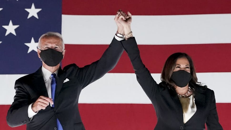 Former Vice President Joe Biden, Democratic presidential nominee, left, and Senator Kamala Harris, Democratic vice presidential nominee, wear protective masks while holding hands outside the Chase Center during the Democratic National Convention in Wilmington, Delaware, U.S., on Thursday, Aug. 20, 2020. Biden accepted the Democratic nomination to challenge President Donald Trump, urging Americans in a prime-time address to vote for new national leadership that will overcome deep U.S. political divisions. Photographer: