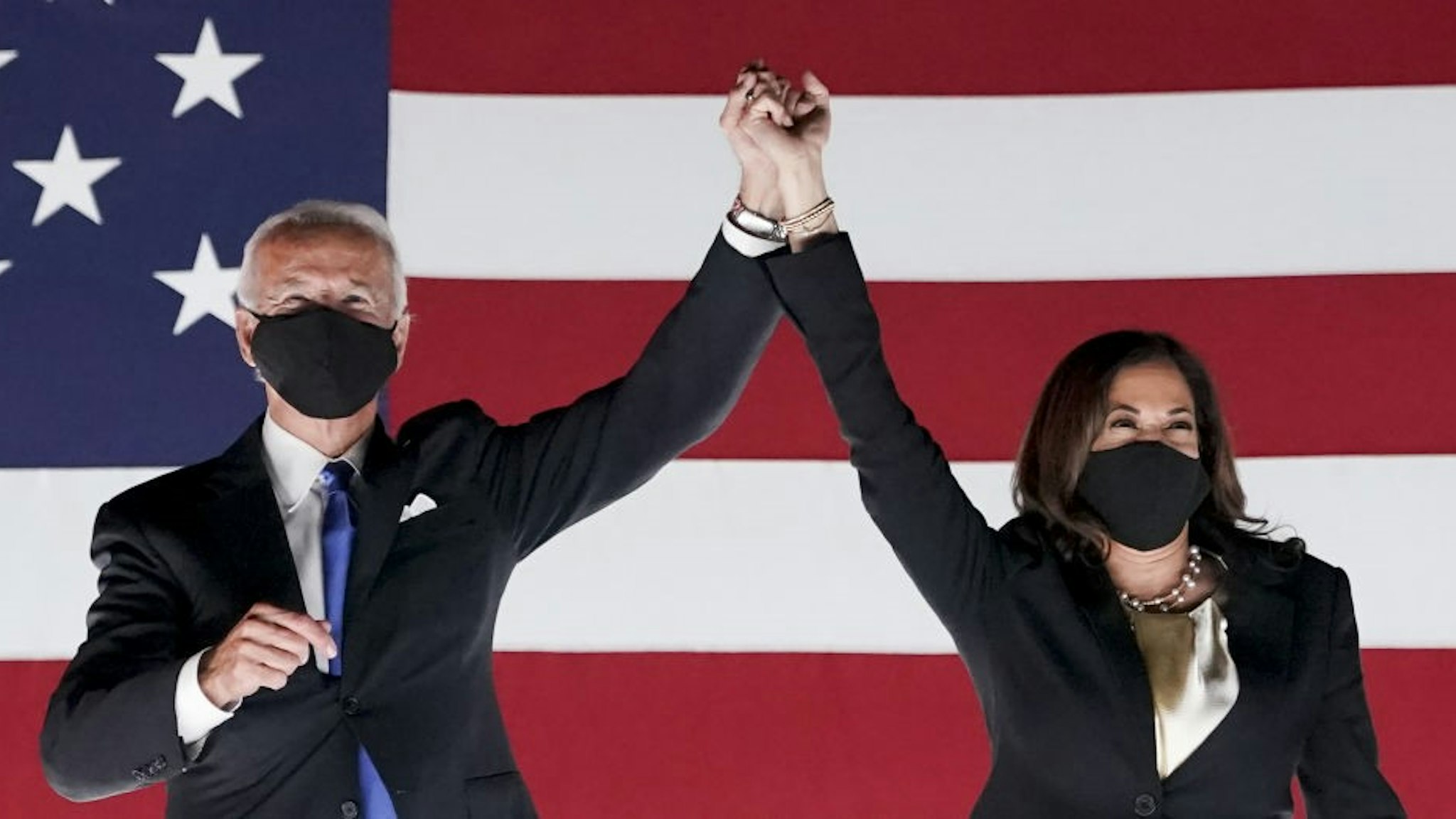 Former Vice President Joe Biden, Democratic presidential nominee, left, and Senator Kamala Harris, Democratic vice presidential nominee, wear protective masks while holding hands outside the Chase Center during the Democratic National Convention in Wilmington, Delaware, U.S., on Thursday, Aug. 20, 2020. Biden accepted the Democratic nomination to challenge President Donald Trump, urging Americans in a prime-time address to vote for new national leadership that will overcome deep U.S. political divisions. Photographer: