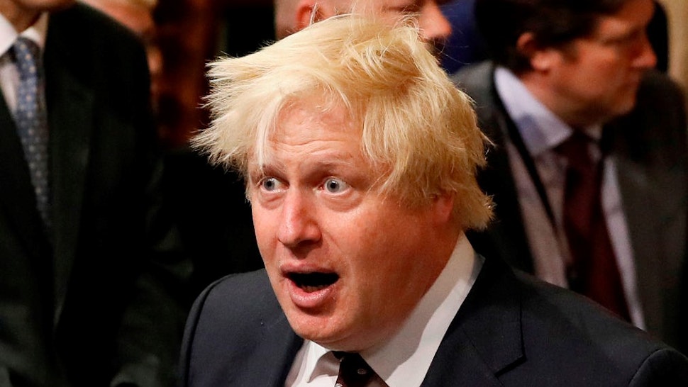LONDON, UNITED KINGDOM - JUNE 21: British Foreign Secretary Boris Johnson walks through the House of Commons to attend the the State Opening of Parliament taking place in the House of Lords at the Palace of Westminster on June 21, 2017 in London, United Kingdom. This year saw a scaled-back State opening of Parliament Ceremony with the Queen arriving by car rather than carriage and not wearing the Imperial State Crown or the Robes of State. (Photo by