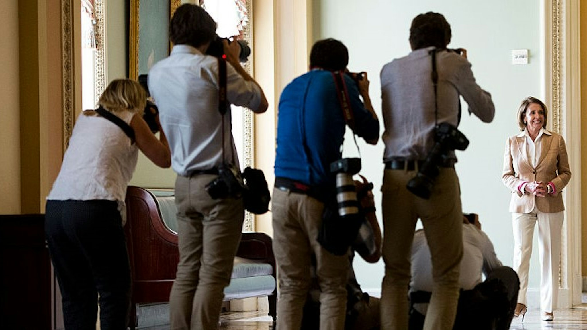 UNITED STATES - JUNE 25: News photographers gather in the Ohio Clock Corridor to photograph House Minority Leader Nancy Pelosi, D-Calif., and Senate Minority Leader Harry Reid, D-Nev., as they walk to their news conference in the Capitol on Thursday, June 25, 2015. (Photo By