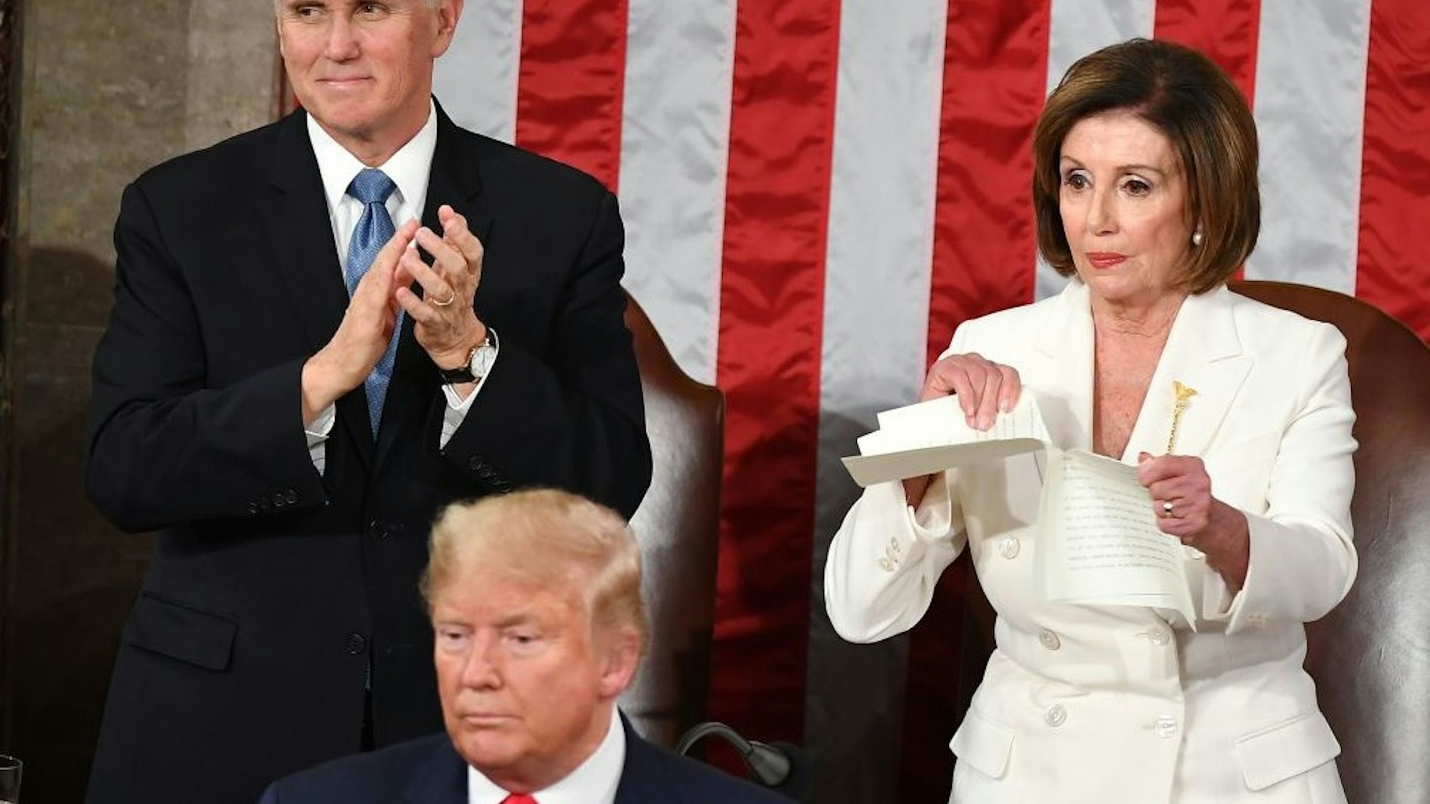 TOPSHOT - Speaker of the US House of Representatives Nancy Pelosi rips a copy of US President Donald Trumps speech after he delivered the State of the Union address at the US Capitol in Washington, DC, on February 4, 2020. (Photo by MANDEL NGAN / AFP) (Photo by