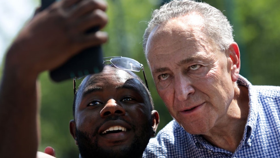 NEW YORK, NY - SEPTEMBER 03: Sen. Chuck Schumer (D-NY) takes a photo with a supporter in the annual West Indian Day Parade on September 3, 2018 in the Brooklyn borough of New York City. The parade is one of the biggest celebrations of Caribbean culture in North America. (Photo by