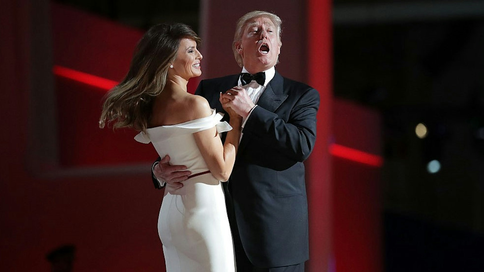 WASHINGTON, DC - JANUARY 20: U.S. President Donald Trump sings to the song "My Way" while dancing with first lady Melania Trump during the inaugural Liberty Ball at the Washington Convention Center January 20, 2017 in Washington, DC. The ball is part of the celebrations following the inauguration Trump. (Photo by