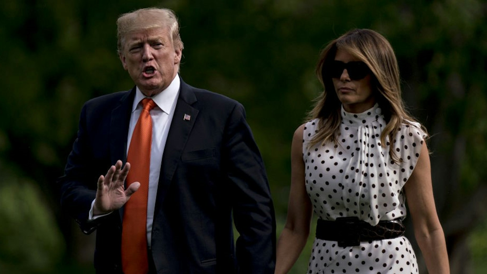 U.S. President Donald Trump waves while walking on the South Lawn of the White House with First Lady Melania Trump after arriving on Marine One in Washington, D.C., U.S., on Wednesday, April 24, 2019. Trump spurned campaign contributions from the pharmaceutical industry today, calling the industry out for its role in a national opioid addiction epidemic. Photographer:
