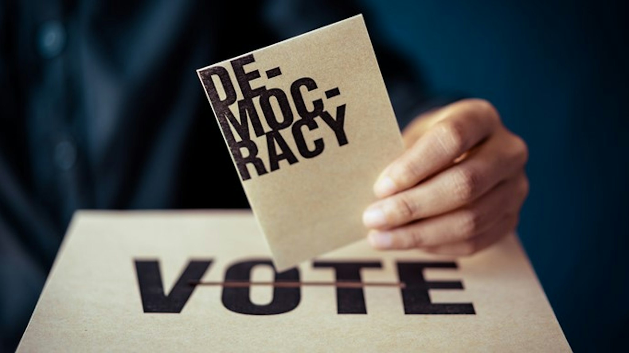 brown paper insert in vote box, democracy concept, retro tone