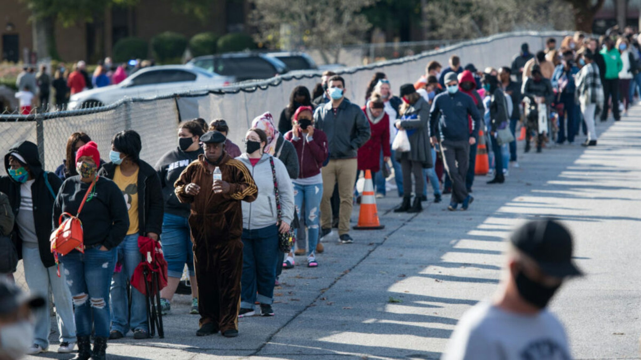 People wait in line to participate in early voting on October 31, 2020 in Greenville, South Carolina. Election Day is November 3.
