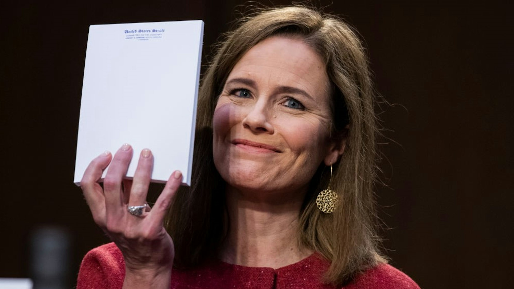 WASHINGTON, DC - OCTOBER 13: Supreme Court justice nominee Amy Coney Barrett holds up her notepad at the request of Sen. John Cornyn, R-Texas, on the second day of her Senate Judiciary Committee confirmation hearing in Hart Senate Office Building on October 13, 2020 in Washington, DC. Barrett was nominated by President Donald Trump to fill the vacancy left by Justice Ruth Bader Ginsburg who passed away in September. (Photo by