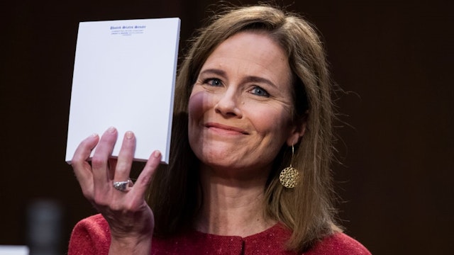 WASHINGTON, DC - OCTOBER 13: Supreme Court justice nominee Amy Coney Barrett holds up her notepad at the request of Sen. John Cornyn, R-Texas, on the second day of her Senate Judiciary Committee confirmation hearing in Hart Senate Office Building on October 13, 2020 in Washington, DC. Barrett was nominated by President Donald Trump to fill the vacancy left by Justice Ruth Bader Ginsburg who passed away in September. (Photo by
