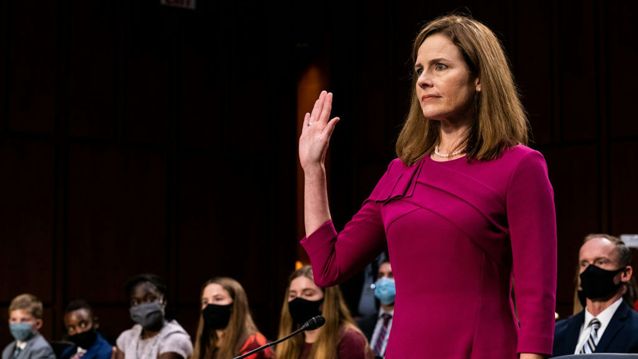Supreme Court Justice nominee Judge Amy Coney Barrett stands as she is sworn in during the Senate Judiciary Committee confirmation hearing for Supreme Court Justice in the Hart Senate Office Building on October 12, 2020 in Washington, DC. With less than a month until the presidential election, President Donald Trump tapped Amy Coney Barrett to be his third Supreme Court nominee in just four years. If confirmed, Barrett would replace the late Associate Justice Ruth Bader Ginsburg. (Erin Schaff-Pool/Getty Images)