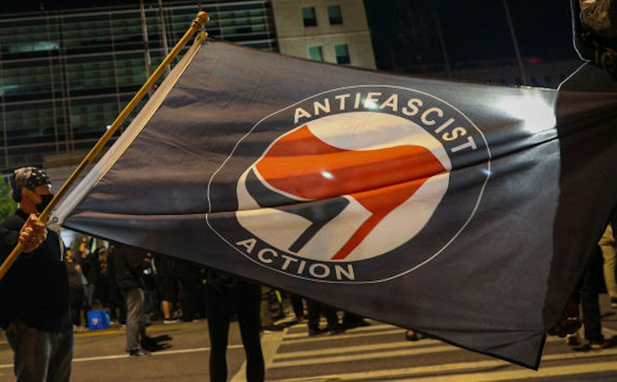 A man holds an anti-fascism flag as hundreds of demonstrators gather and march to the City Public Safety Building over Daniel Prudeâs death in Rochester, New York, United States on September 6, 2020. Daniel Prude, an unarmed black man who died after being arrested and being placed a "spit hood" over his head by Rochester police. (Photo by Tayfun Coskun/Anadolu Agency via Getty Images)