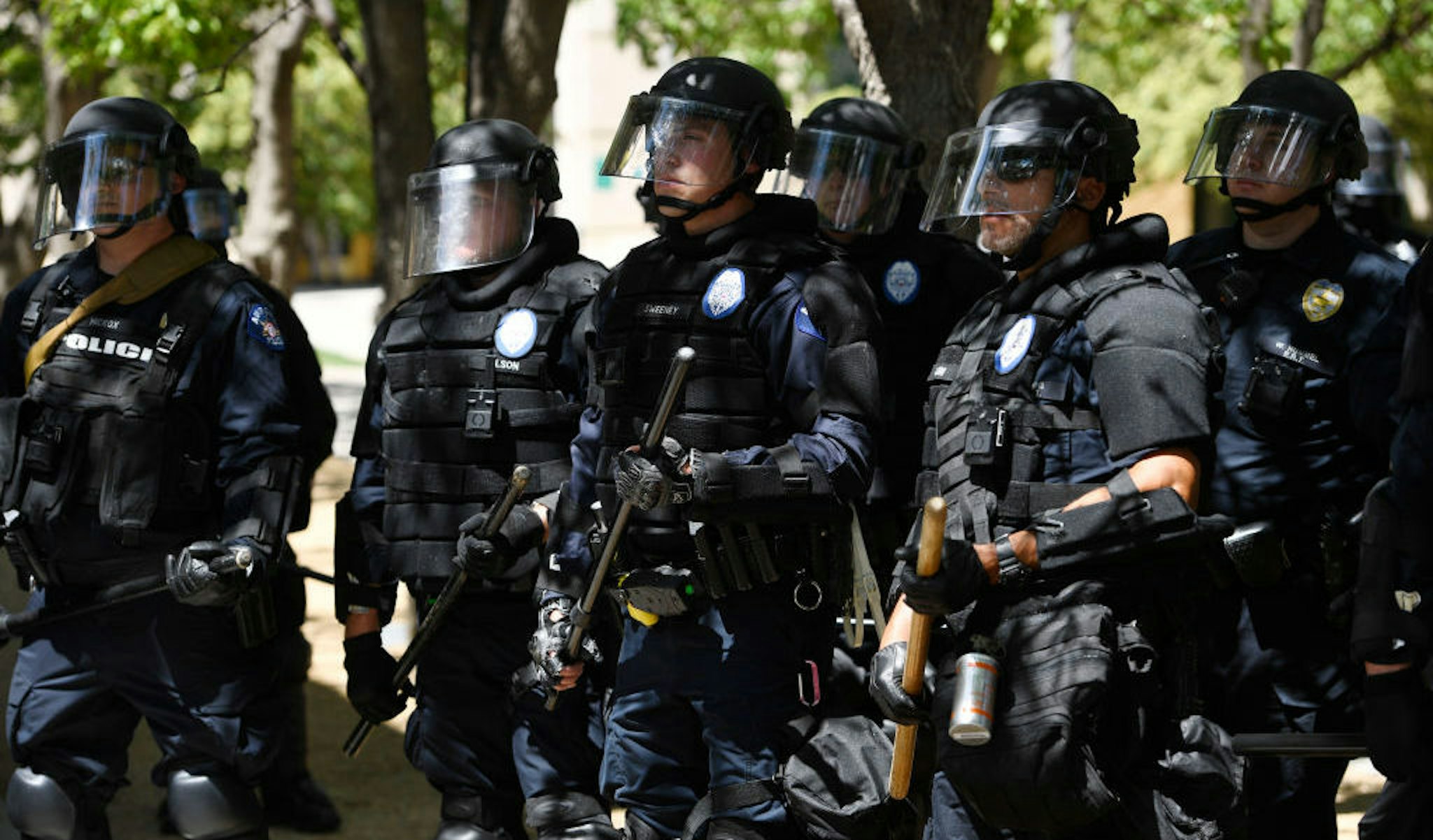 AURORA, CO - JUNE 27: Aurora police in full riot gear at the ready behind a police fence during a Elijah McClain protest in front of the Aurora Police department's headquarters at the Aurora Municipal Center June 27, 2020. Elijah McClain died August 30, 2019 several days after a struggle with Aurora police. Elijah became unconscious during the encounter with police August 24, 2019 and had a heart attack while being transported to a hospital. McClain died after being taken off life support. (Photo by Andy Cross/The Denver Post)