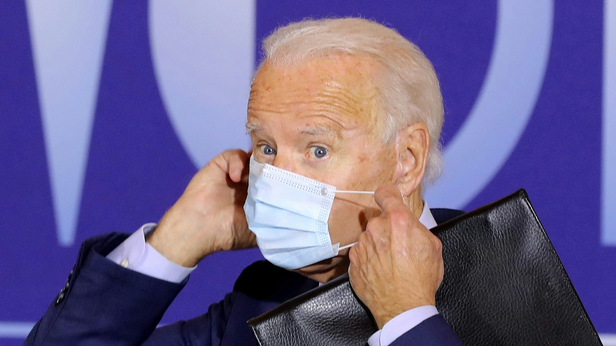 CINCINNATI, OH - OCTOBER 12: Democratic presidential nominee Joe Biden replaces his face mask after delivering remarks during a voter-mobilization event at the Cincinnati Museum Center at Union Terminal October 12, 2020 in Cincinnati, Ohio. With 21 days until the election, Biden is campaigning in Toledo and Cincinnati.