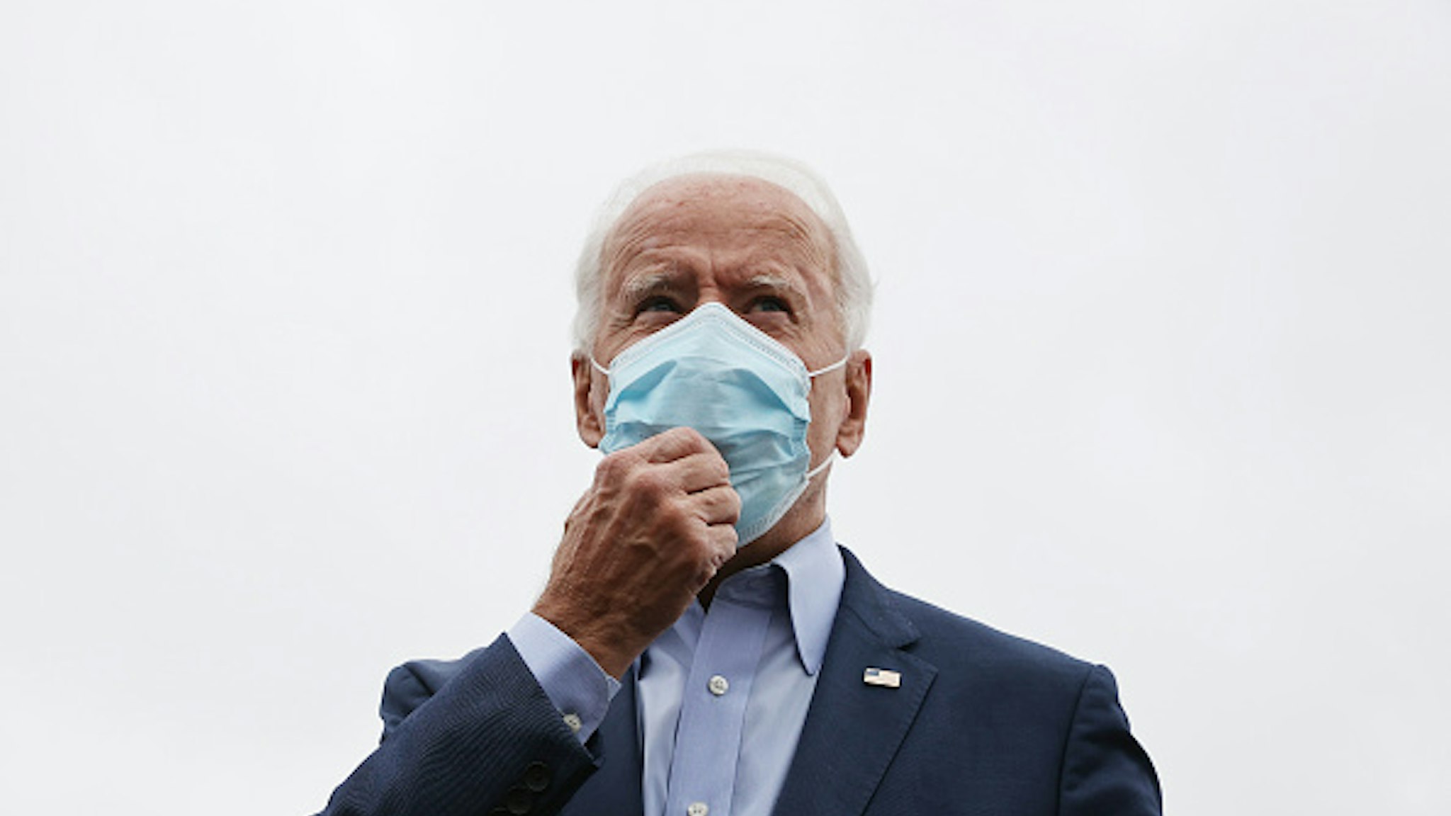 NEW CASTLE, DELAWARE - OCTOBER 12: Wearing a face mask to reduce the risk posed by the coronavirus, Democratic presidential nominee Joe Biden talks to reporters before boarding a flight to Ohio at New Castle County Airport October 12, 2020 in New Castle, Delaware. With 21 days until the election, Biden will campaign in Toledo and Cincinnati.