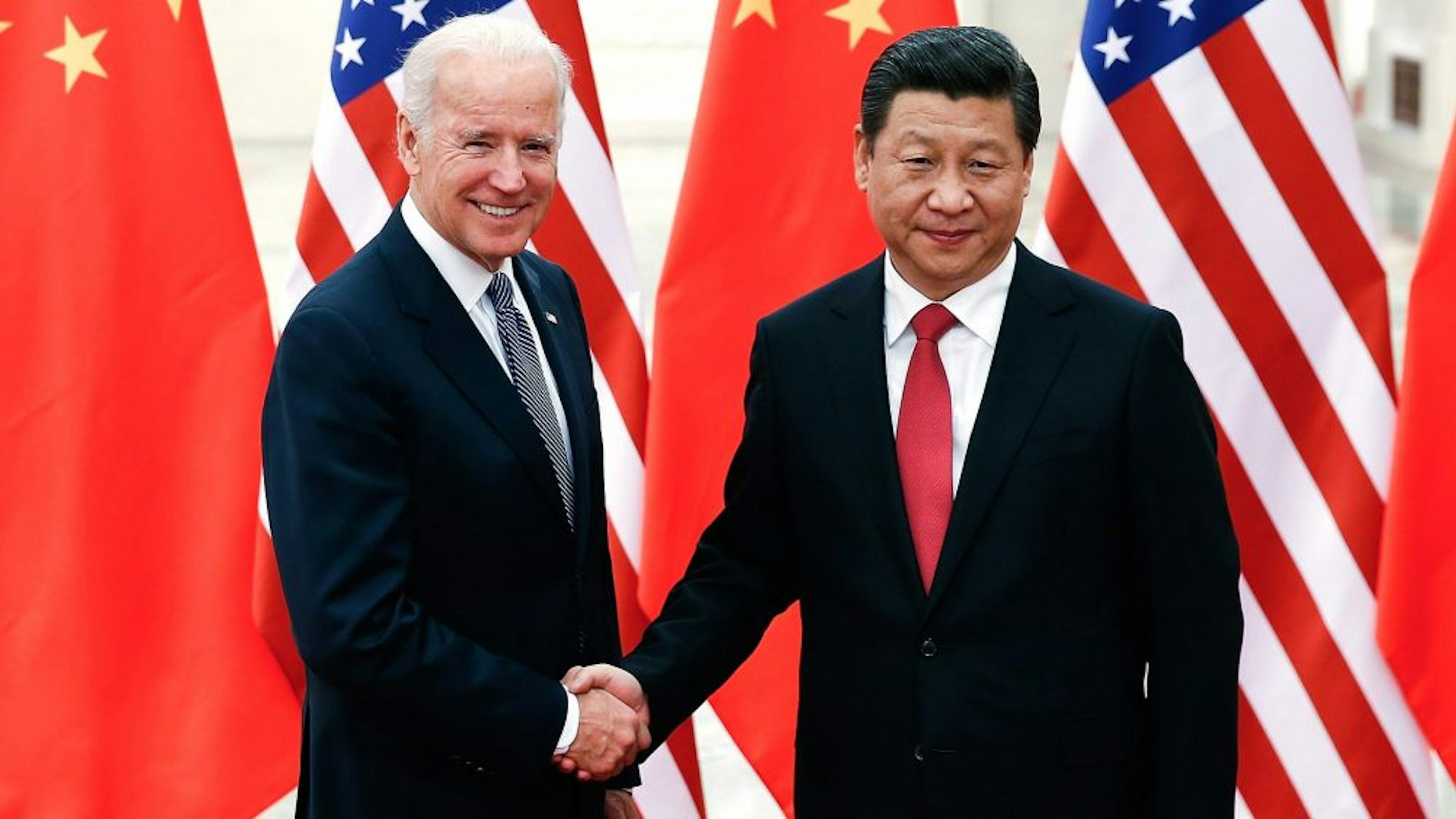BEIJING, CHINA - DECEMBER 04: Chinese President Xi Jinping (R) shake hands with U.S Vice President Joe Biden (L) inside the Great Hall of the People on December 4, 2013 in Beijing, China. U.S Vice President Joe Biden will pay an official visit to China from December 4 to 5.