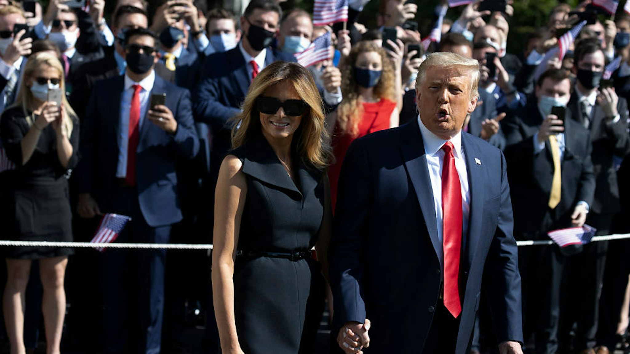 First Lady Melania Trump and President Donald Trump walk to the South Lawn to depart the White House on October 22, 2020 in Washington, DC. President Trump travels to Nashville, Tennessee for the final debate with Democratic presidential nominee Joe Biden. The Commission on Presidential Debates changed the format this time, muting of microphones to start each of Thursday's debate segments. (Photo by Tasos Katopodis/Getty Images)