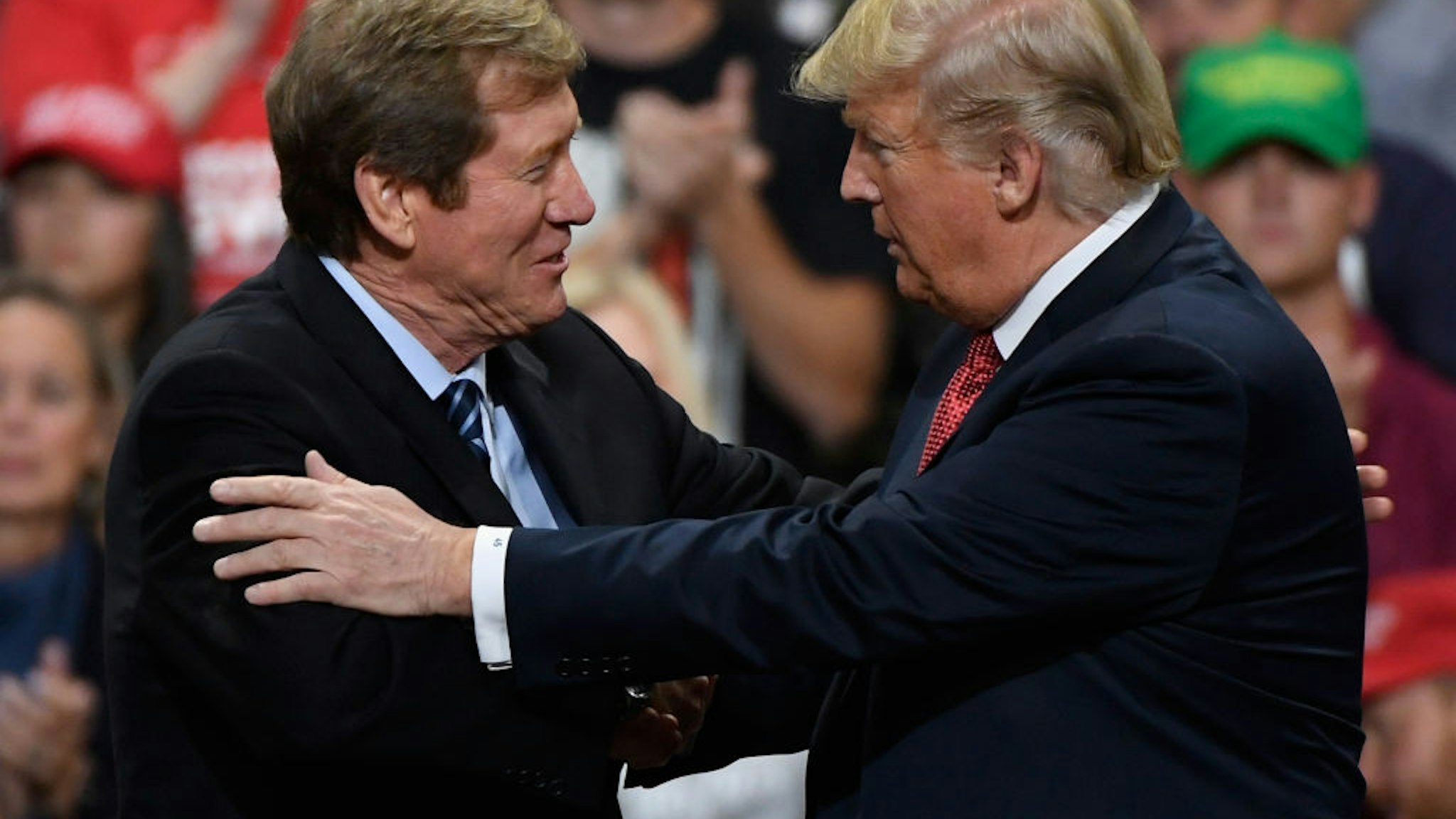 US President Donald Trump greets Jason Lewis, Republican US Congressman from Minnesota's 2nd district, at a campaign rally on October 4, 2018 at Mayo Civic Center in Rochester, Minnesota.
