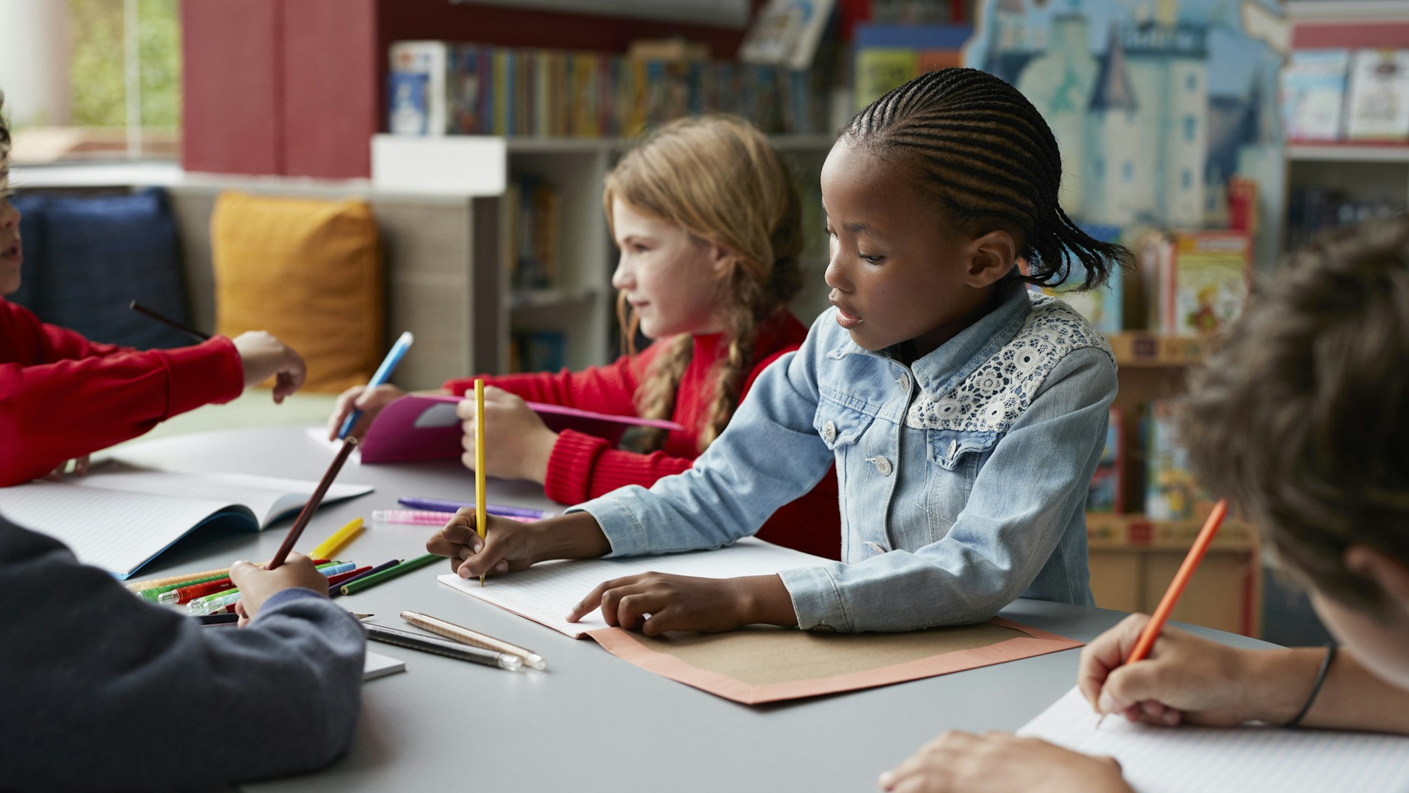 School children drawing at the school library - stock photo