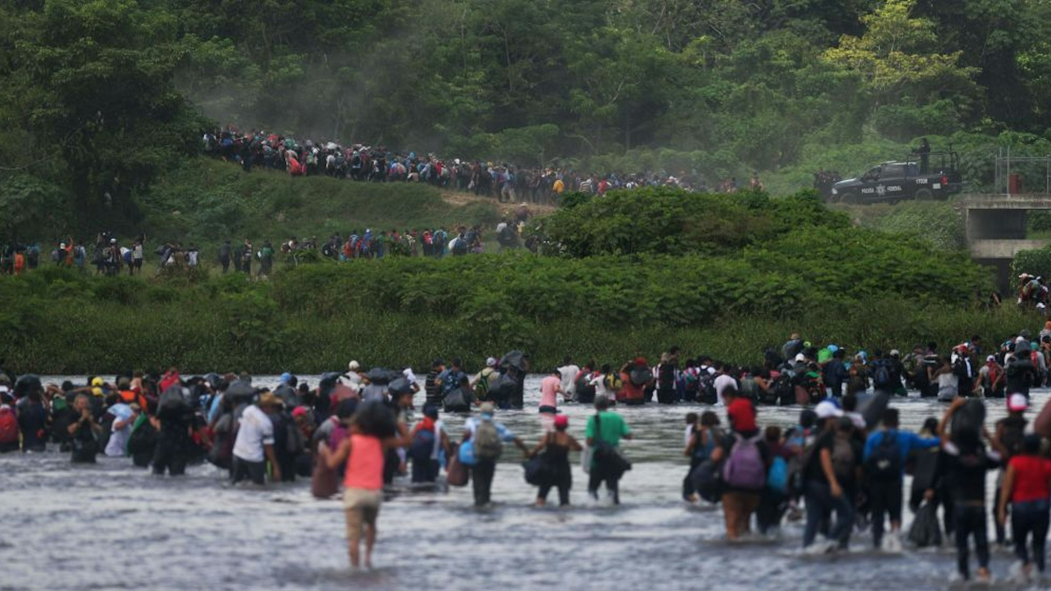 Salvadorean migrants heading in a caravan to the US, cross the Suchiate River to Mexico, as seen from Ciudad Tecun Uman, Guatemala, on November 02, 2018.