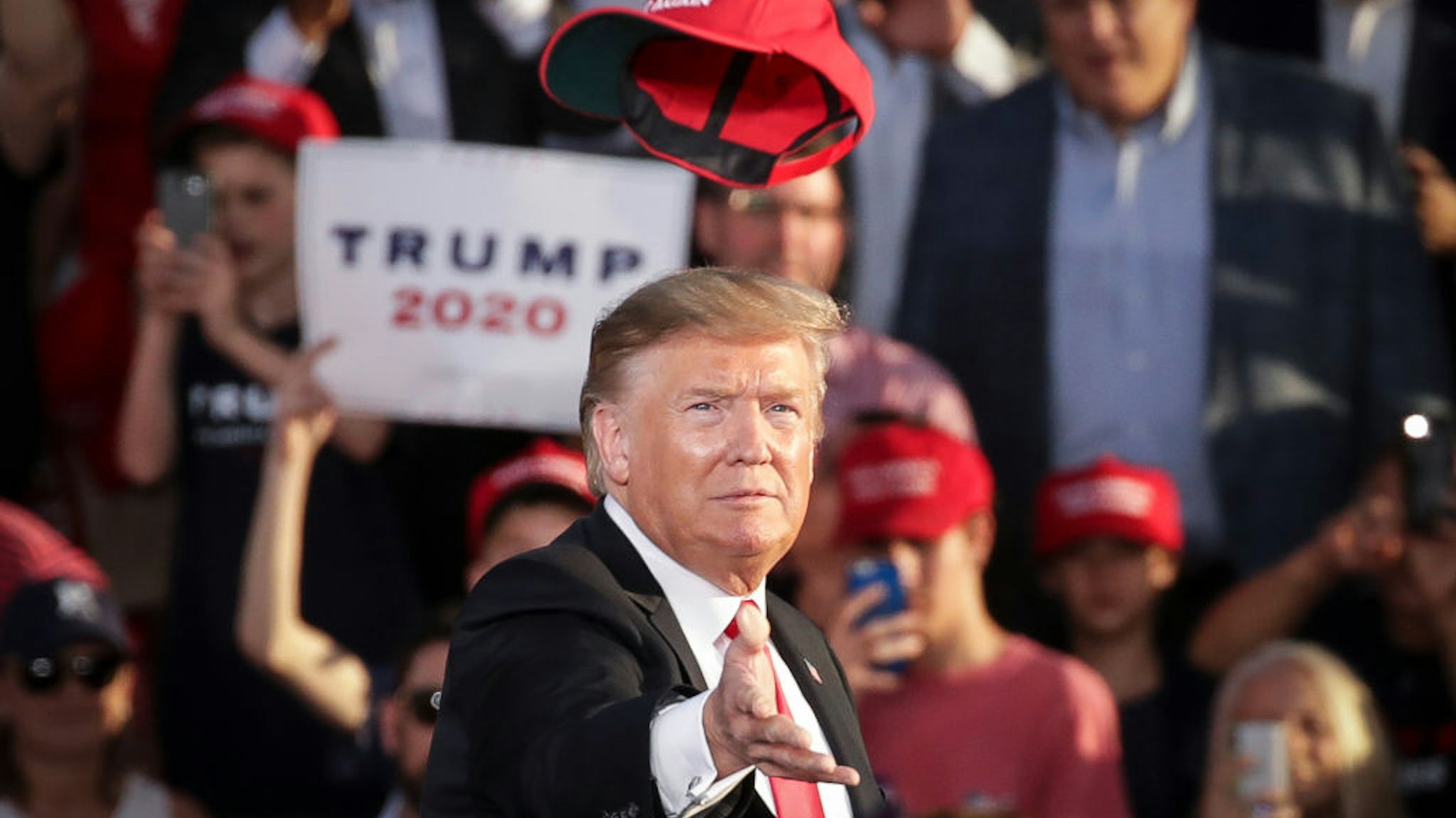 President Donald Trump tosses a hat into the crowd as he arrives for a 'Make America Great Again' campaign rally at Williamsport Regional Airport, May 20, 2019 in Montoursville, Pennsylvania.