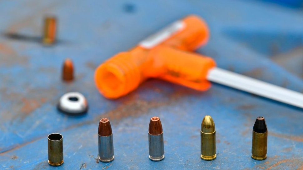 9mm. rounds, including the catridge of a decoupled bullet, wait to be loaded into a hand-held pistol at a firing range to demosntrate the inert effect of the separated-bullet when fired at Kenya's National Gun Owners Association