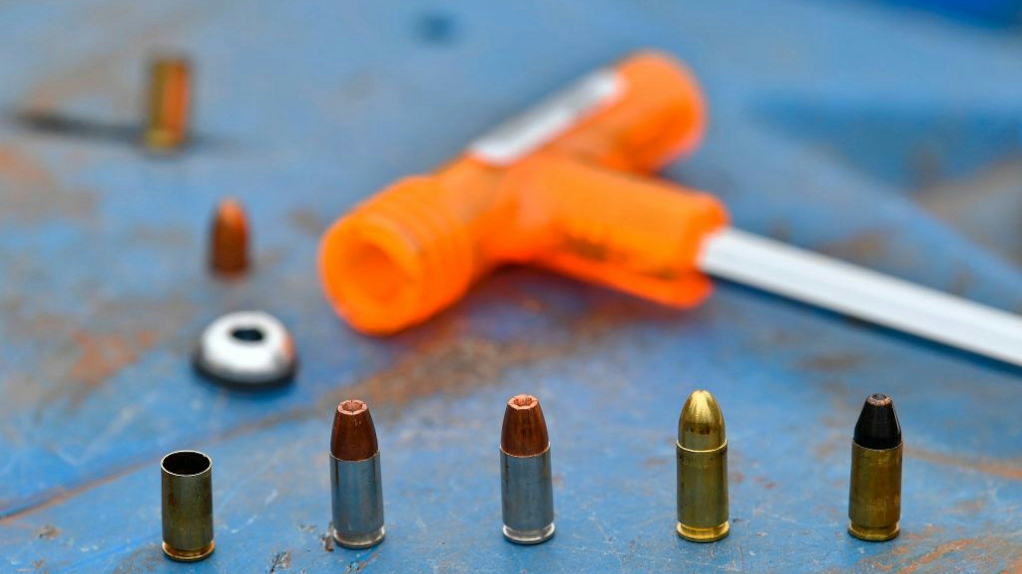 9mm. rounds, including the catridge of a decoupled bullet, wait to be loaded into a hand-held pistol at a firing range to demosntrate the inert effect of the separated-bullet when fired at Kenya's National Gun Owners Association