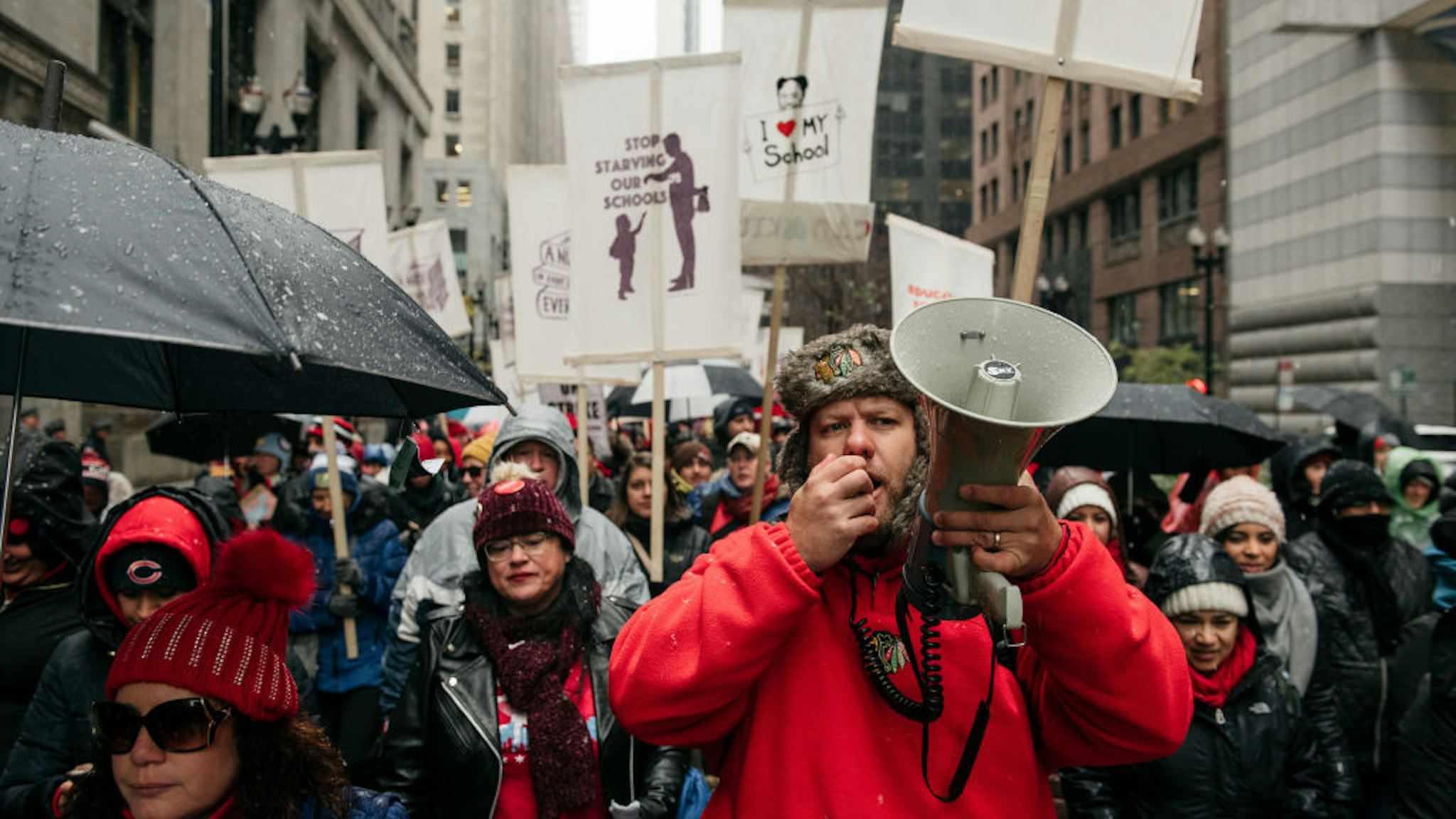 Braving snow and cold temperatures, thousands marched through the streets near City Hall during the 11th day of an ongoing teachers strike on October 31, 2019 in Chicago, Illinois.