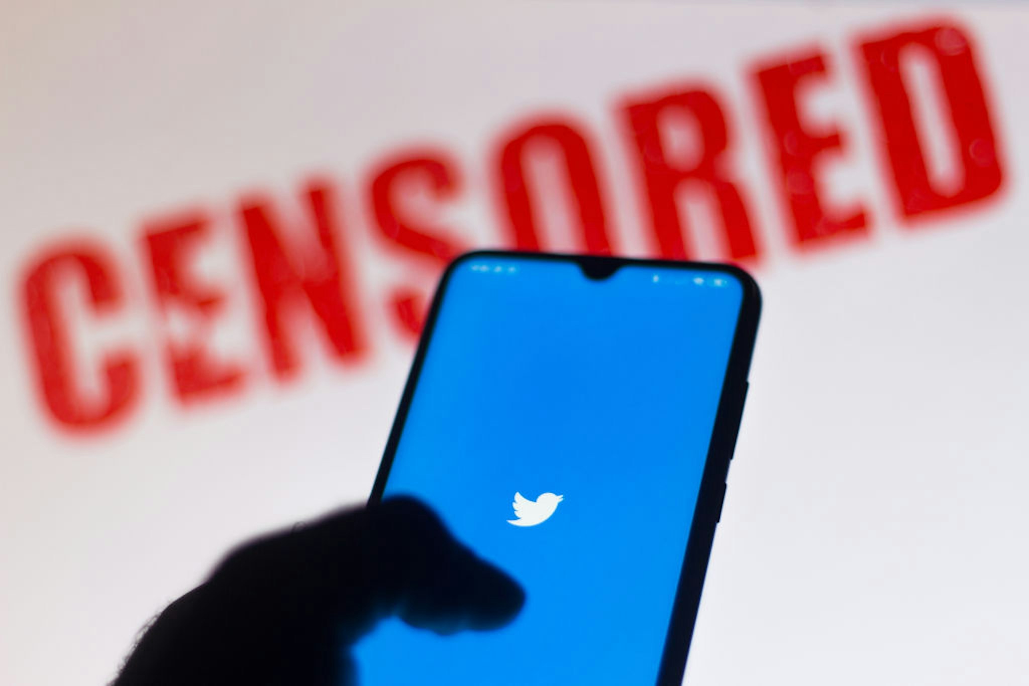 BRAZIL - 2020/06/15: In this photo illustration the Twitter logo is displayed on a smartphone and a red alerting word "CENSORED" on the blurred background. (Photo Illustration by Rafael Henrique/SOPA Images/LightRocket via Getty Images)